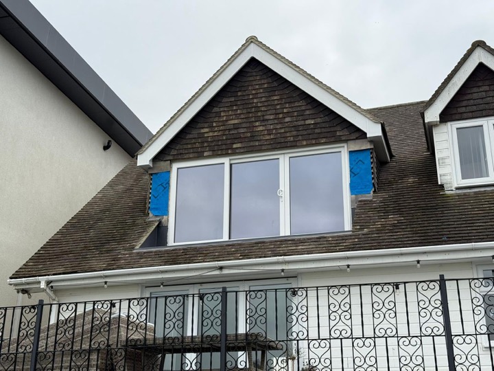 Dormer picture window set into a tiled roof